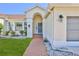 Inviting front entrance with a brick walkway, arched entryway, and well-kept landscaping at 10285 Rosetti Ct, Spring Hill, FL 34608