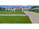 Charming single-story home with a well-manicured lawn, complemented by an extended driveway leading to a two-car garage at 10285 Rosetti Ct, Spring Hill, FL 34608