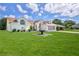 Well-maintained home exterior featuring lush lawn, landscape, and inviting curb appeal at 10285 Rosetti Ct, Spring Hill, FL 34608