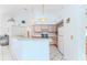 Well lit kitchen with tiled floors, pink cabinets, and light fixtures at 10285 Rosetti Ct, Spring Hill, FL 34608