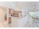 Charming kitchen features pink cabinets, a breakfast bar, and lots of natural light at 10285 Rosetti Ct, Spring Hill, FL 34608