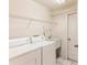 Laundry room with washer, dryer, utility sink and shelving for storage at 10285 Rosetti Ct, Spring Hill, FL 34608