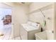 Laundry room with washer, dryer, utility sink and shelving for storage at 10285 Rosetti Ct, Spring Hill, FL 34608