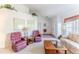 Cozy living room featuring vaulted ceilings, neutral carpet, and large windows for ample light at 10285 Rosetti Ct, Spring Hill, FL 34608