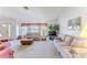 Bright living room features two sofas, a window with natural light, and neutral colored carpeting at 10285 Rosetti Ct, Spring Hill, FL 34608