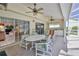 Inviting covered patio with ceiling fans, dining table set, sliding glass doors leading to the home's interior at 10285 Rosetti Ct, Spring Hill, FL 34608
