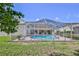 Backyard featuring a screened pool with clear blue water, bordered by green grass and a privacy screen at 10285 Rosetti Ct, Spring Hill, FL 34608