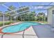 Sparkling pool surrounded by a screened enclosure, perfect for outdoor relaxation and entertaining at 10285 Rosetti Ct, Spring Hill, FL 34608