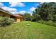 Large backyard showing the yard's size and trees creating a natural space at 11101 Ragsdale Ct, New Port Richey, FL 34654