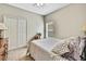 Comfortable bedroom with a cozy bed, a side table with a lamp, and a view from the window at 11101 Ragsdale Ct, New Port Richey, FL 34654