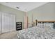 Cozy bedroom featuring carpet, closet and bright window, decorated with floral bedding and a wooden headboard at 11101 Ragsdale Ct, New Port Richey, FL 34654