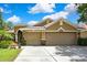 Inviting home featuring a three-car garage, manicured landscaping, and a neutral color palette at 11101 Ragsdale Ct, New Port Richey, FL 34654