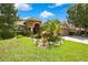 Charming single-story home with lush landscaping, vibrant plants, and a well-maintained lawn at 11101 Ragsdale Ct, New Port Richey, FL 34654