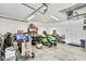 Spacious garage featuring riding lawn mower, work bench and tools at 11101 Ragsdale Ct, New Port Richey, FL 34654