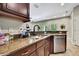 Stylish kitchen with stainless appliances, granite countertops, under-cabinet lighting, and a black faucet at 11101 Ragsdale Ct, New Port Richey, FL 34654