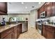 Well-equipped kitchen featuring stainless steel appliances, dark wood cabinetry, and ample counter space at 11101 Ragsdale Ct, New Port Richey, FL 34654