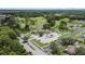 Aerial view of the community featuring a golf course, a pond, and mature trees at 11621 Pear Tree Dr, New Port Richey, FL 34654