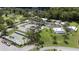 Aerial view of the community featuring a pool, mature trees, and ample parking at 11621 Pear Tree Dr, New Port Richey, FL 34654