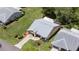 Aerial view of home with a two-car garage, screened-in patio, and landscaped yard at 11621 Pear Tree Dr, New Port Richey, FL 34654