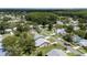 Aerial view of several homes in the neighborhood surrounded by lush trees at 11621 Pear Tree Dr, New Port Richey, FL 34654
