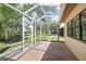 Open back patio with a screen enclosure, perfect for outdoor enjoyment and relaxing at 11621 Pear Tree Dr, New Port Richey, FL 34654
