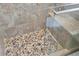 Stylish shower with a pebble floor, glass enclosure, and neutral tiling at 11621 Pear Tree Dr, New Port Richey, FL 34654