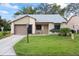 Charming single-story home with well-maintained lawn and attached garage at 11621 Pear Tree Dr, New Port Richey, FL 34654