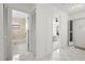 Tiled hallway with the bathroom on the left and the bedroom on the right at 11621 Pear Tree Dr, New Port Richey, FL 34654