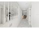 Bright hallway with white tile floors that leads to the living room and kitchen at 11621 Pear Tree Dr, New Port Richey, FL 34654