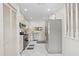 Open kitchen with stainless steel appliances, white cabinets, and tile flooring at 11621 Pear Tree Dr, New Port Richey, FL 34654