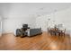 Spacious open-concept living area with hardwood floors that connects to the dining area at 11621 Pear Tree Dr, New Port Richey, FL 34654