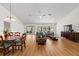 Bright open-plan living and dining area featuring hardwood floors and sliding doors at 11621 Pear Tree Dr, New Port Richey, FL 34654