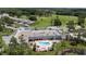 Aerial view of building with pool surrounded by lawn chairs with a view of the golf course at 11621 Pear Tree Dr, New Port Richey, FL 34654