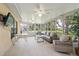Bright sunroom with comfortable seating, tiled flooring, and views of the landscaped backyard at 11621 Pear Tree Dr, New Port Richey, FL 34654