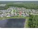 Aerial view of a home surrounded by other homes, lake and green space, showing the location at 11876 Ranchers Gap Dr, Odessa, FL 33556