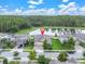 Aerial view of a home with a pond view, showcasing the surrounding neighborhood and landscape at 11876 Ranchers Gap Dr, Odessa, FL 33556
