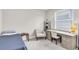 Bedroom featuring a desk, chair, and window with natural light at 11876 Ranchers Gap Dr, Odessa, FL 33556