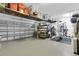 Spacious garage equipped with overhead storage racks, shelving, and a work out area at 11876 Ranchers Gap Dr, Odessa, FL 33556