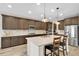 Modern kitchen featuring an island, granite countertops, stainless appliances, and hardwood floors at 11876 Ranchers Gap Dr, Odessa, FL 33556