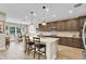Modern kitchen featuring quartz countertops, stainless steel appliances, and a breakfast bar at 11876 Ranchers Gap Dr, Odessa, FL 33556