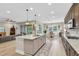 Well-lit kitchen with an island, modern appliances, and hardwood floors overlooking the living area at 11876 Ranchers Gap Dr, Odessa, FL 33556