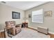 Comfortable living room with chair, ottoman, and window with natural light at 11876 Ranchers Gap Dr, Odessa, FL 33556