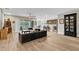 Open-concept living room showcasing hardwood floors, a ceiling fan, and sliding glass doors at 11876 Ranchers Gap Dr, Odessa, FL 33556