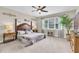 Spacious main bedroom with ample natural light and a ceiling fan at 11876 Ranchers Gap Dr, Odessa, FL 33556