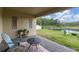 Covered patio area overlooking a backyard and pond, perfect for outdoor relaxation at 11876 Ranchers Gap Dr, Odessa, FL 33556