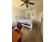 Bedroom featuring a bed, dresser, and ceiling fan with ensuite bathroom at 12104 Boynton Ln, New Port Richey, FL 34654