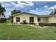 This attractive home features a well-maintained lawn and mature landscaping at 12104 Boynton Ln, New Port Richey, FL 34654