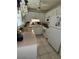 Traditional style kitchen with white cabinets, and modern appliances at 12104 Boynton Ln, New Port Richey, FL 34654