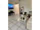 Open living room featuring tile floors, neutral paint, and a modern entertainment center at 12104 Boynton Ln, New Port Richey, FL 34654
