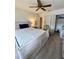 Comfortable bedroom featuring neutral walls, ceiling fan, and ample closet space at 12104 Boynton Ln, New Port Richey, FL 34654